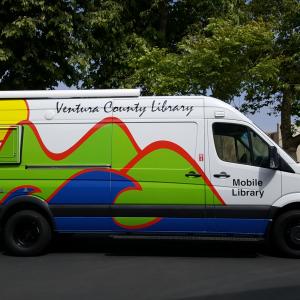 Ventura County Mobile Library photo - a large while van with the VCL mountains, sea, and sun logo on the side