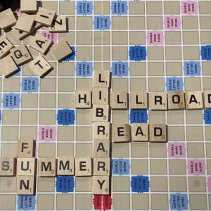 scrabble game tiles spell out words like Hill Road, Library, Read, Summer, Fun